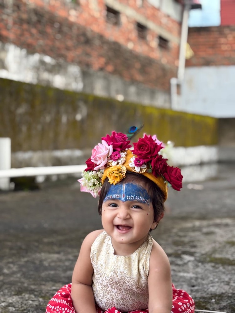 A joyful baby celebrating Krishna