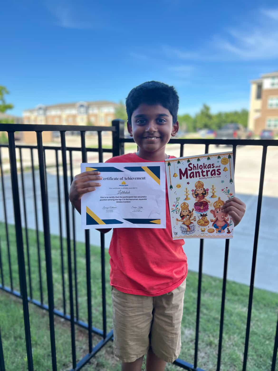 Lalitaksh, second place winner of Shloka Nidhi shloka contest, receiving certificate and shloka books